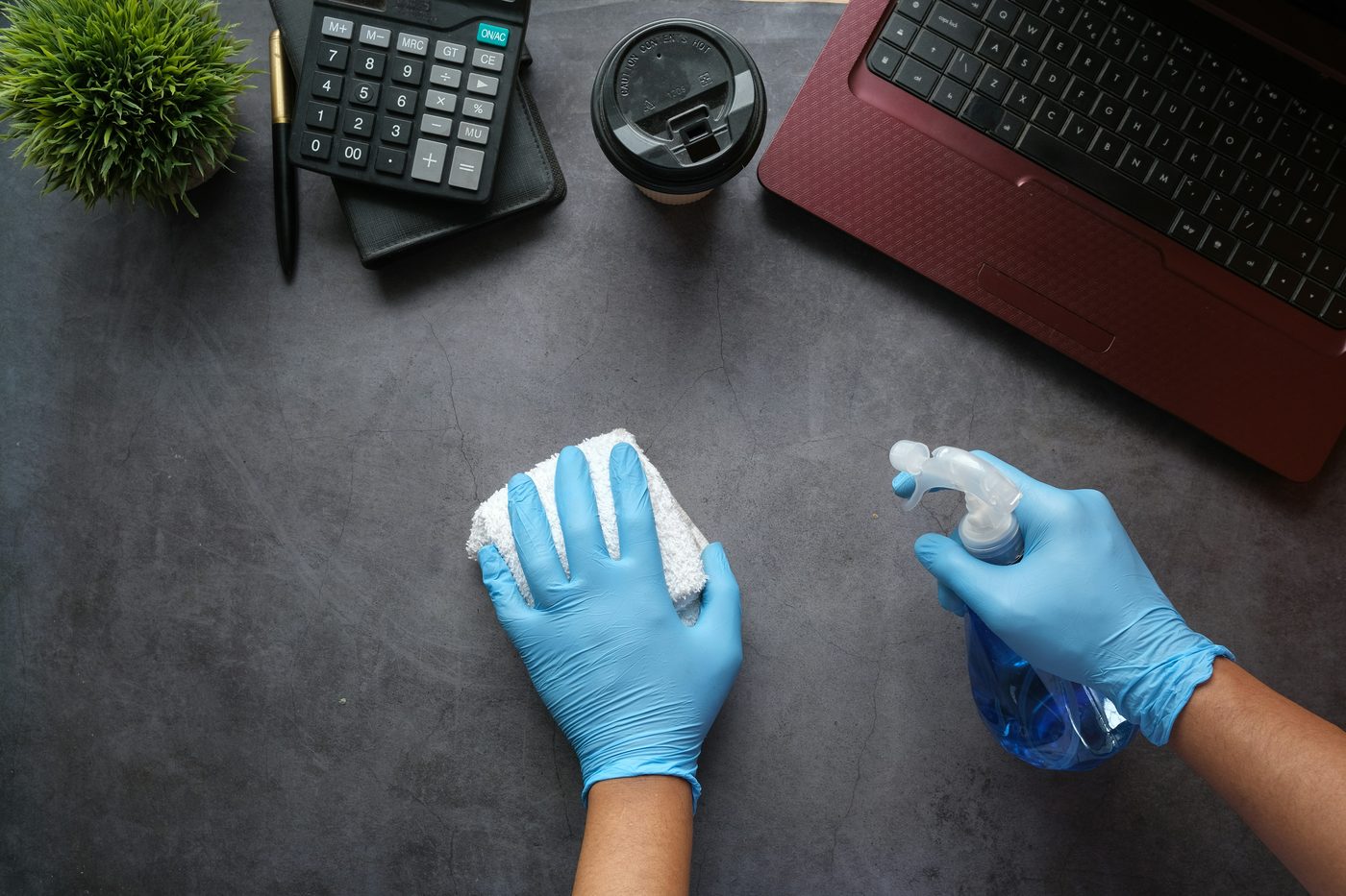 Office desk being cleaned and sanitised